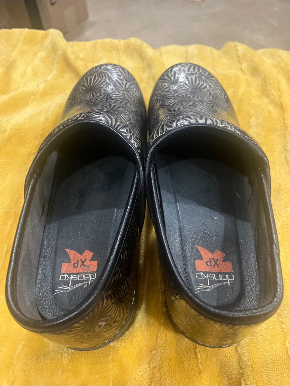Dansko Black Floral-Embossed Slip-On Clogs